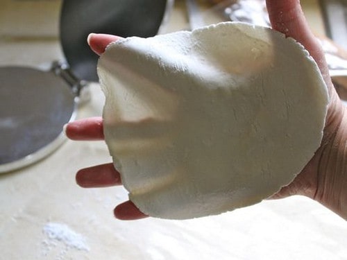 Gluten-Free Flour Tortilla dough being held in hand.