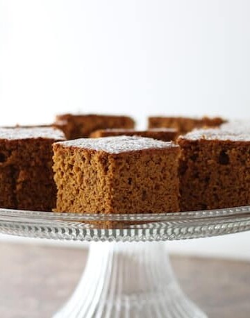 Gluten-Free Ginger Pumpkin Bread on a glass cake stand.