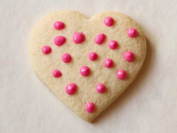 Gluten-free sugar cookie with pink chocolate polka dots.