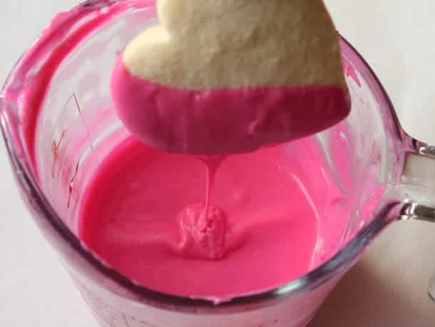 Heart shaped gluten-free sugar cookie dipped in pink chocolate.
