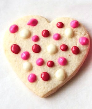 Gluten-free sugar cookie hearts frosted with polka dots.