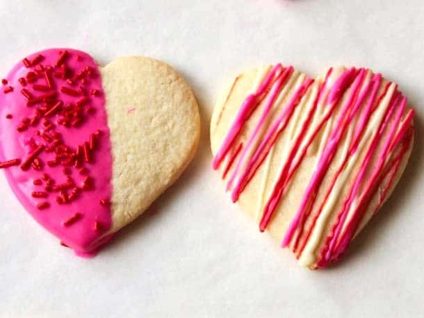 Cookie dipped in pink chocolate with sprinkles. Cookie drizzled with red, pink, and white chocolate.