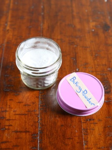 Jar of paleo baking powder. Pink lid is labeled with tape that reads "baking powder".
