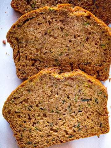 Slices of gluten-free zucchini bread on a cutting board.