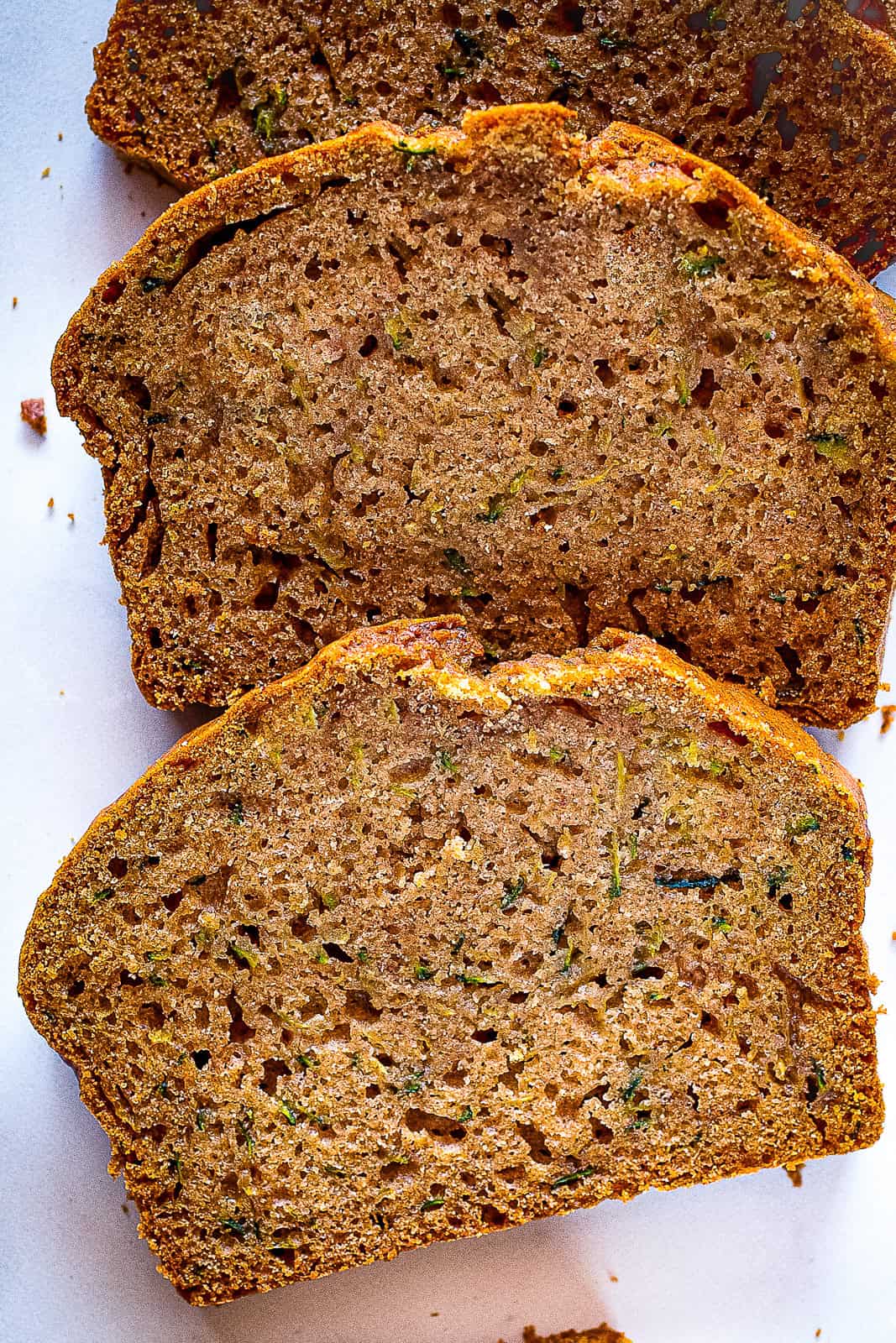 Slices of gluten-free zucchini bread on a cutting board.