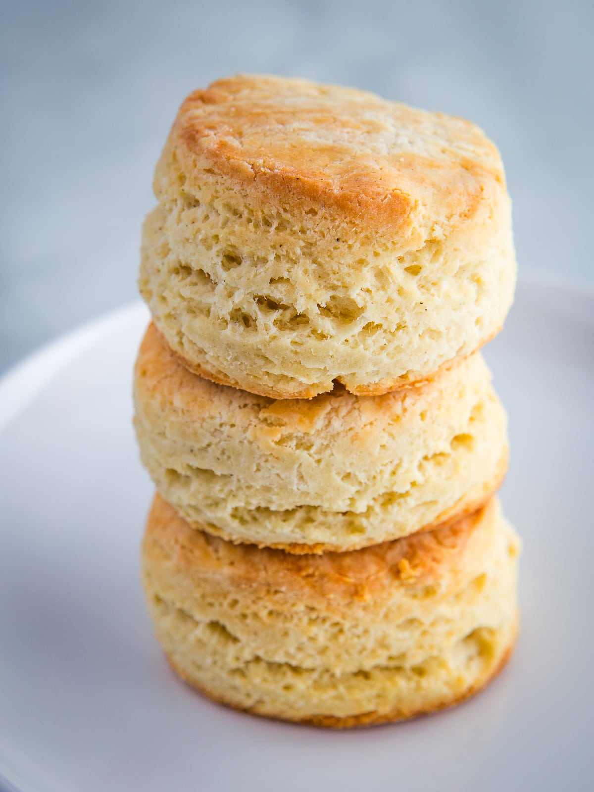 Three baked gluten-free biscuits in a stack.
