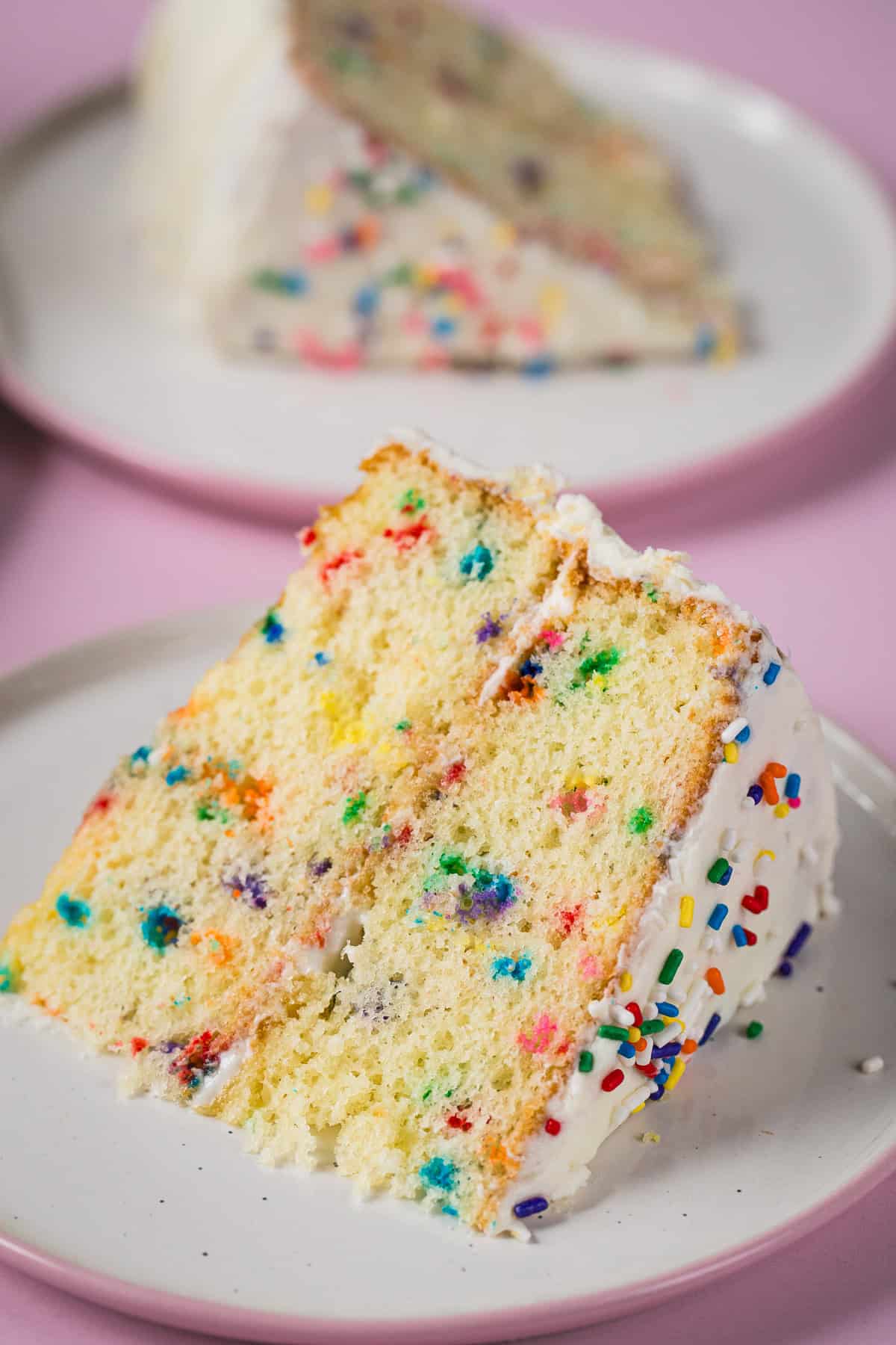 Slice of gluten-free confetti cake on a plate.