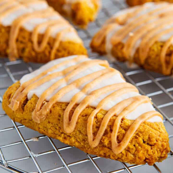 Gluten-free pumpkin scone glazed on a wire rack.